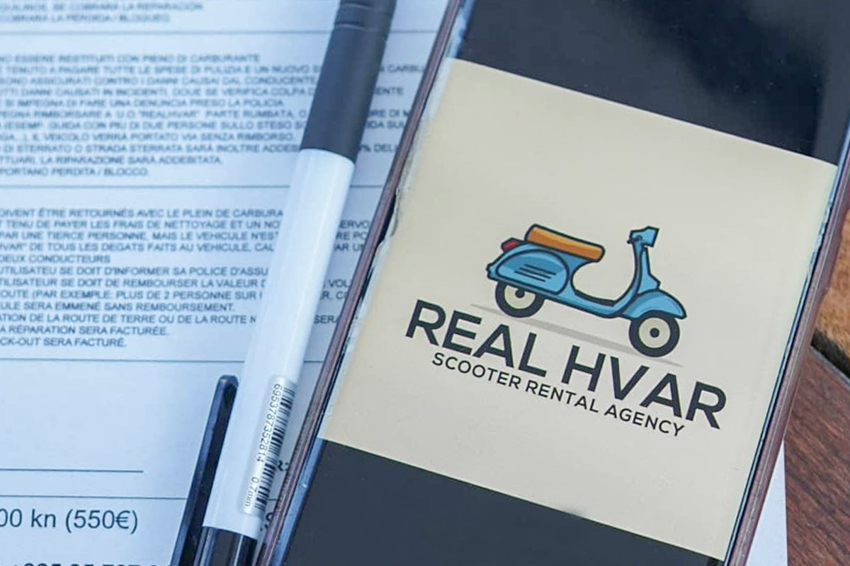 a photo of a logo from Real Hvar rental agency on a phone with the contract in the background